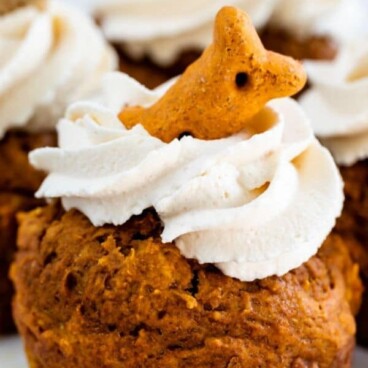 Close up shot of pumpkin pupcake with dog bone on top and recipe title on top of image