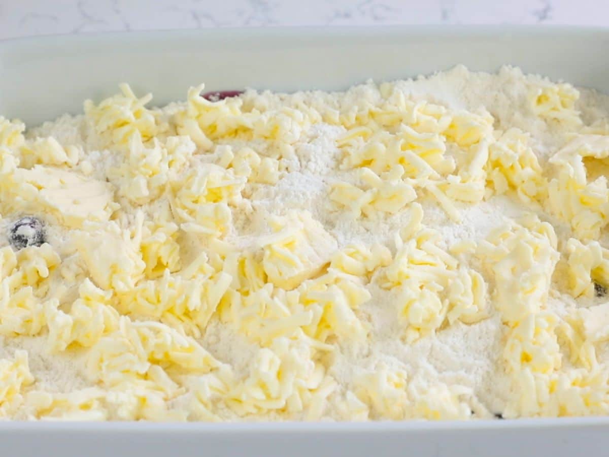 pan with cake mix and shredded butter.