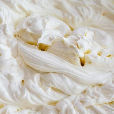 Whipped cream frosting swirls with recipe title on top of image