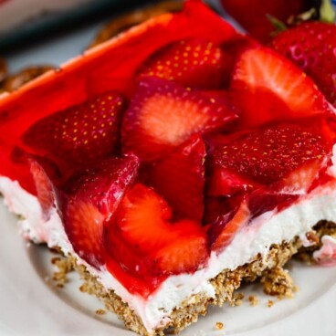 One square of strawberry pretzel salad on a white plate