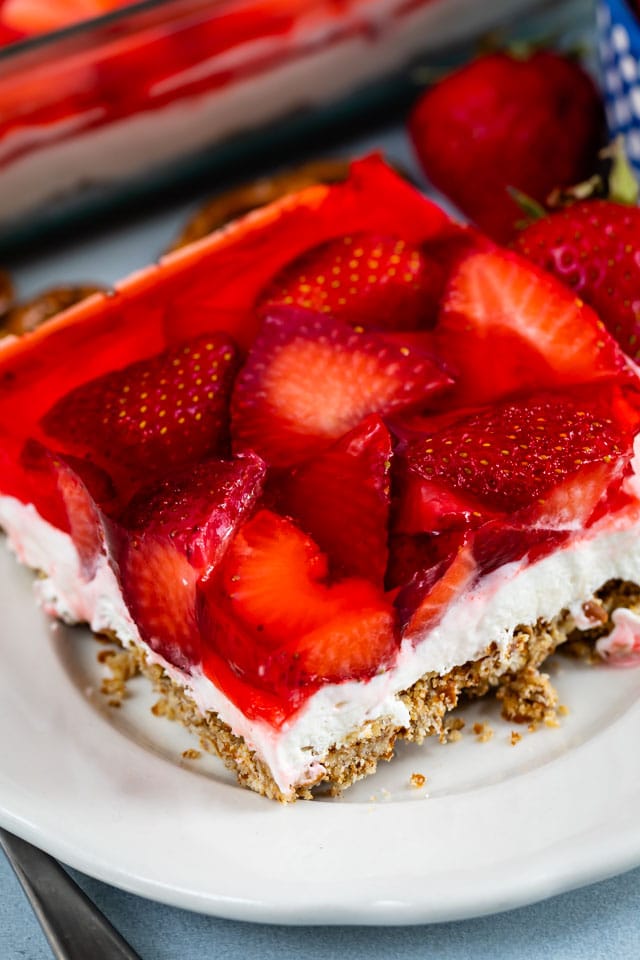 One square of strawberry pretzel salad on a white plate