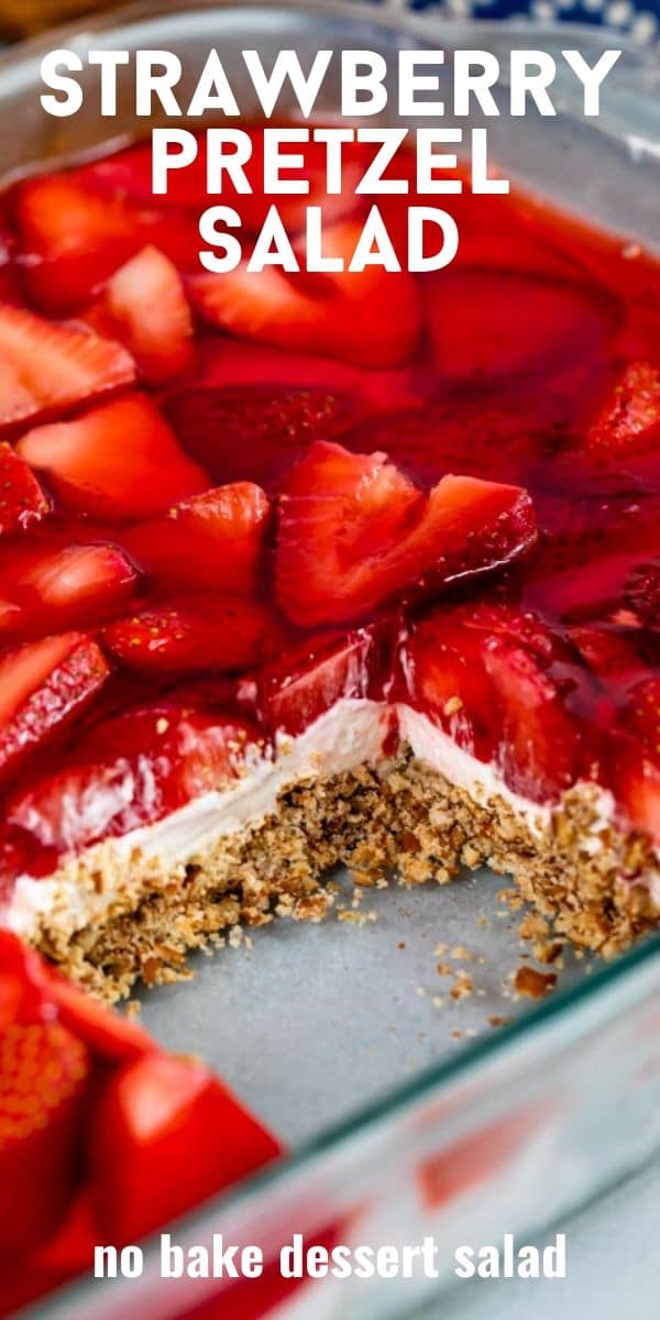 Strawberry pretzel salad in glass baking dish with one square missing with recipe title in text on top of image