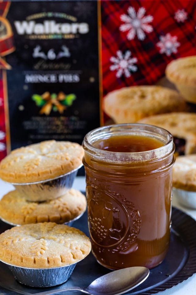 jar of caramel sauce on metal plate with walkers mince pies
