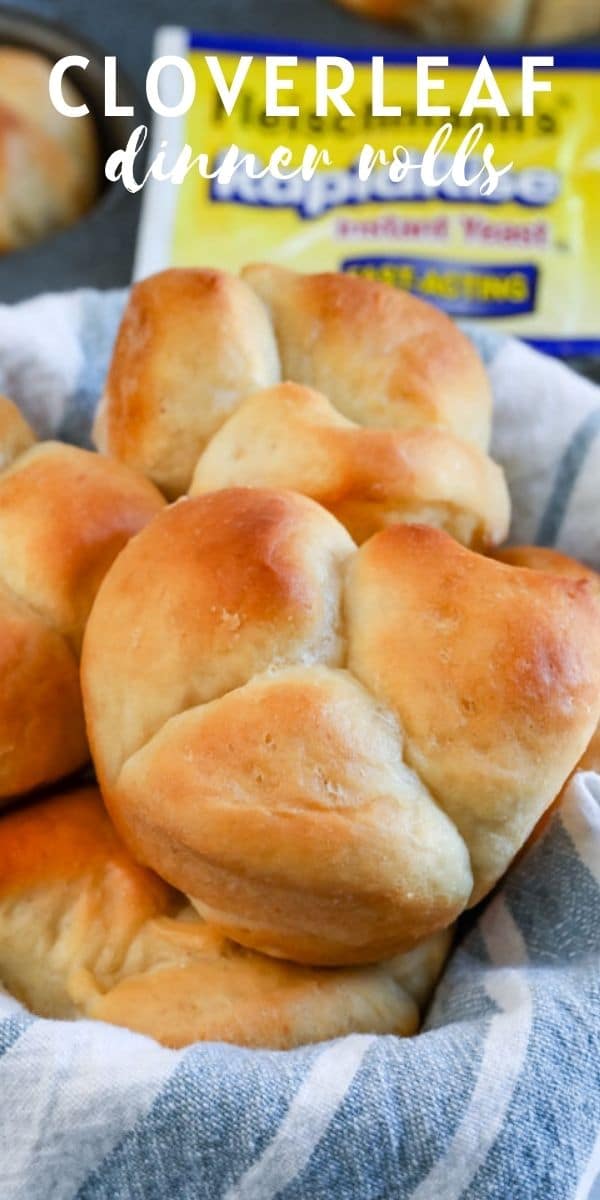 Close up of cloverleaf dinner rolls in a roll basket with recipe title on top