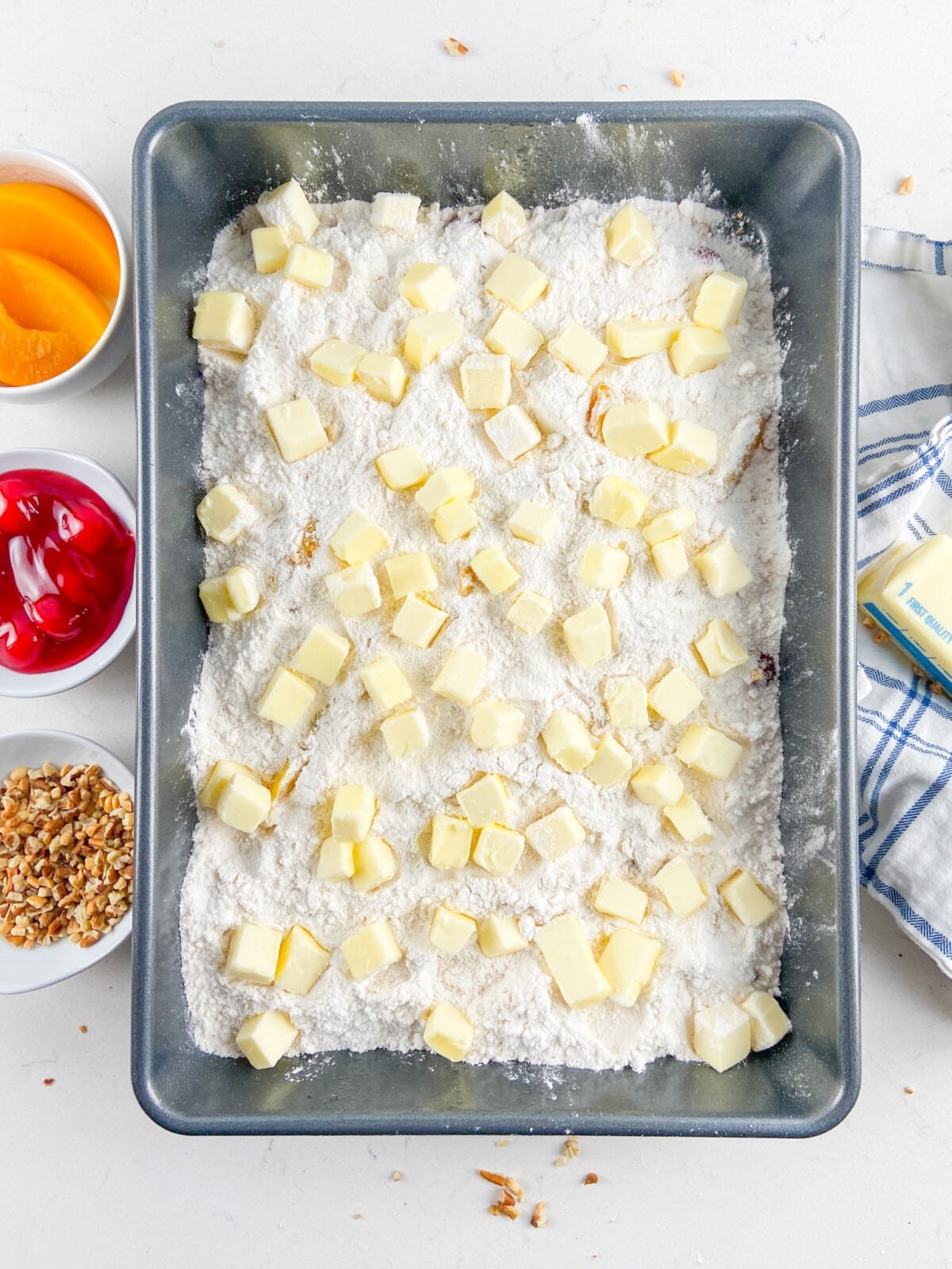 pan with pie filling and cake mix and butter on top