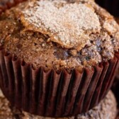 Two chocolate zucchini muffins stacked with recipe title on top