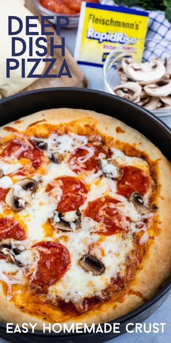 Overhead shot of deep dish pizza in a cake pan with ingredients scattered around it