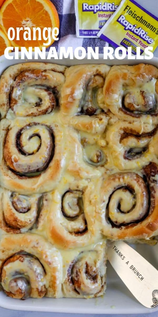 Overhead shot of orange sweet rolls in a baking dish with one cut out of the corner and recipe title on top