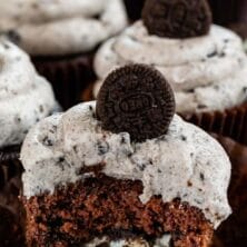 Oreo cupcake cut in half to show oreo cookie inside cupcake with recipe title on top