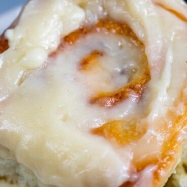 cinnamon roll on plate with words on photo