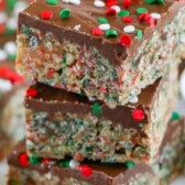 Stack of holiday no bake cereal bars with recipe title on top of image