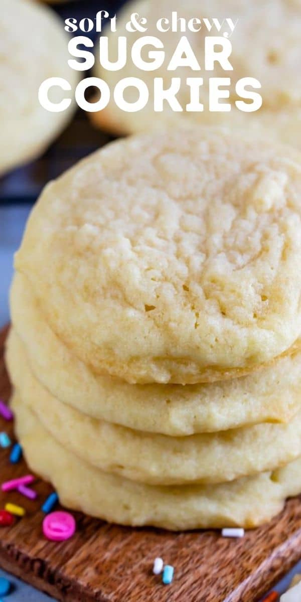 Stack of the best sugar cookies on a wood cutting board with recipe title on top