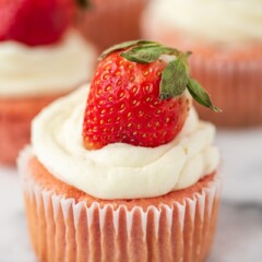 Strawberry cheesecake cupcake with white chocolate frosting and strawberry on top