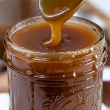 Salted caramel in a mason jar with spoon picking some of it out