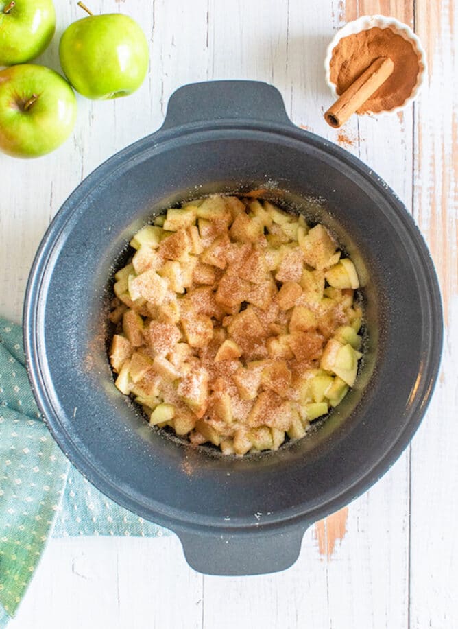 Overhead shot of apple dump cake ingredients in slow cooker