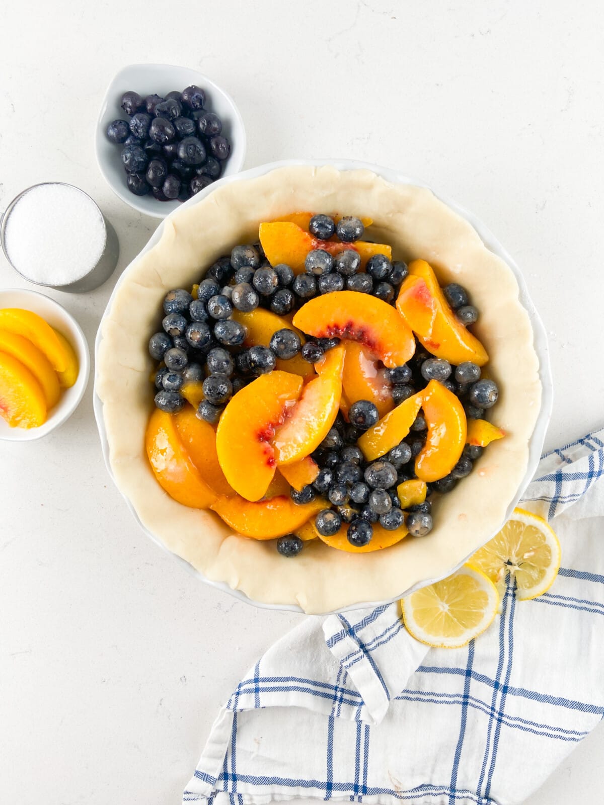 pie crust filled with peaches and blueberries