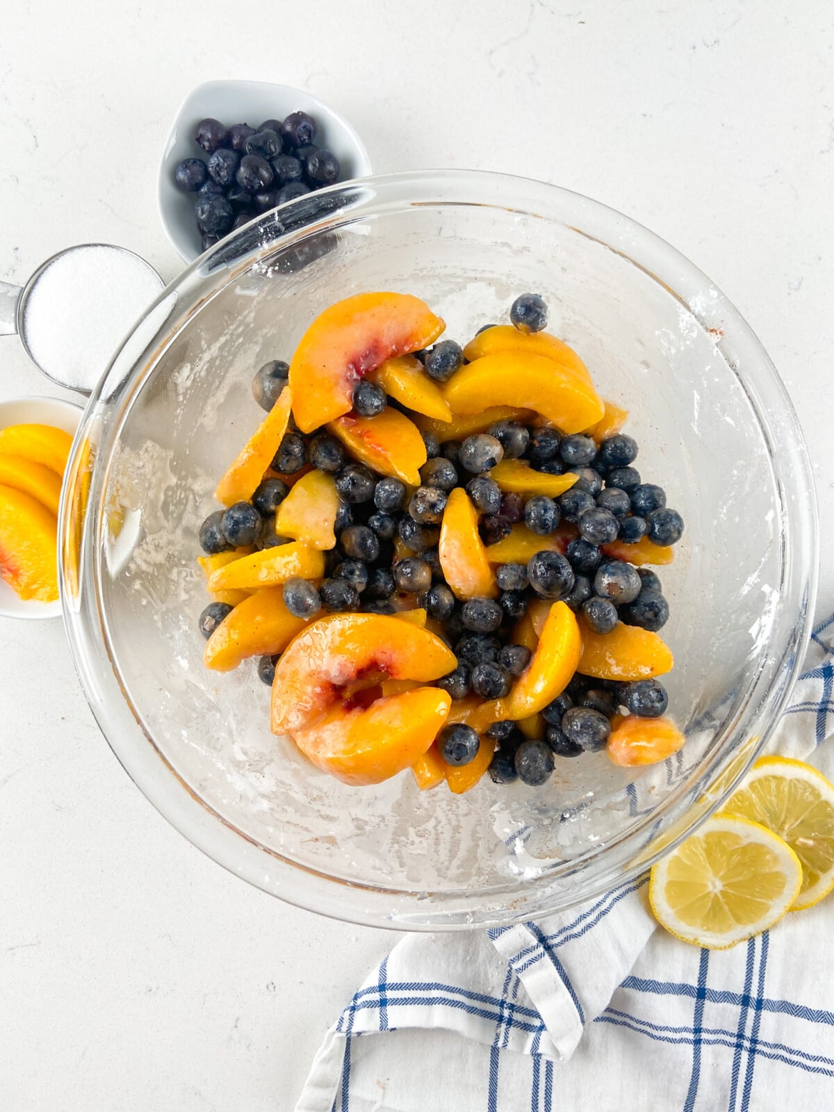 peaches and blueberries in clear glass bowl