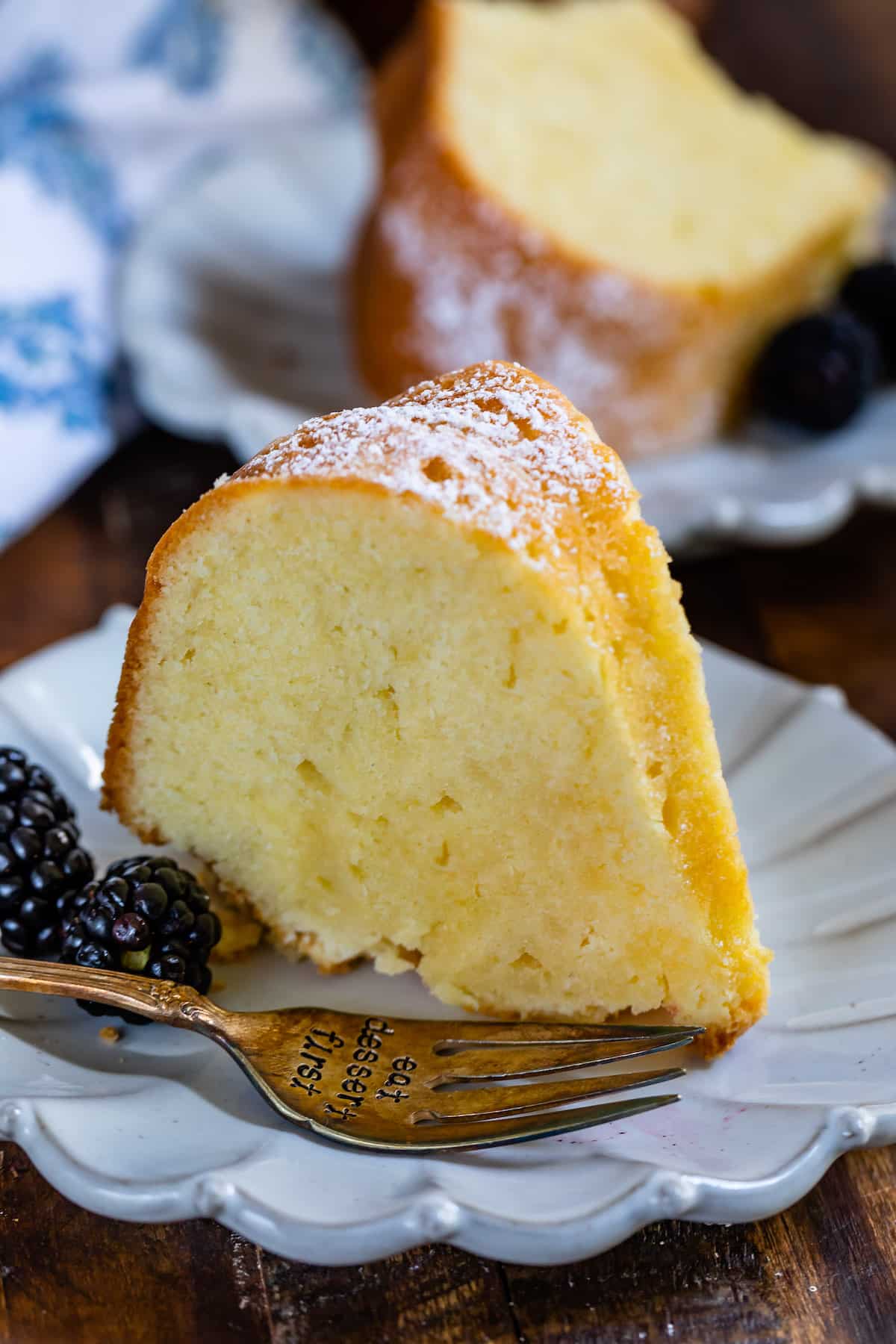 slice of pound cake standing on white plate with fork