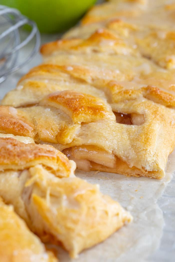 Easy apple strudel cut into small pieces on parchment paper