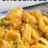 Cheesy chicken casserole on a grey dish with rest of casserole in background and recipe title on image
