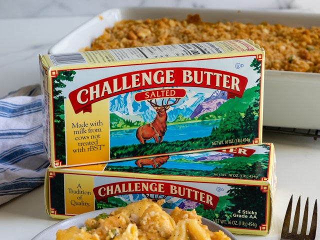 Two challenge butter boxes stacked on eachother with cheesy chicken casserole in background