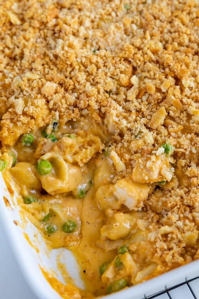 Overhead shot of easy cheesy chicken casserole in casserole dish with corner piece missing