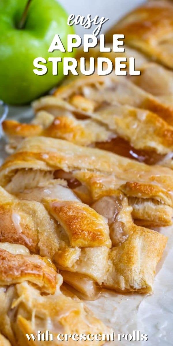 Easy apple strudel cut into pieces on parchment paper with green apple in background and recipe title on top