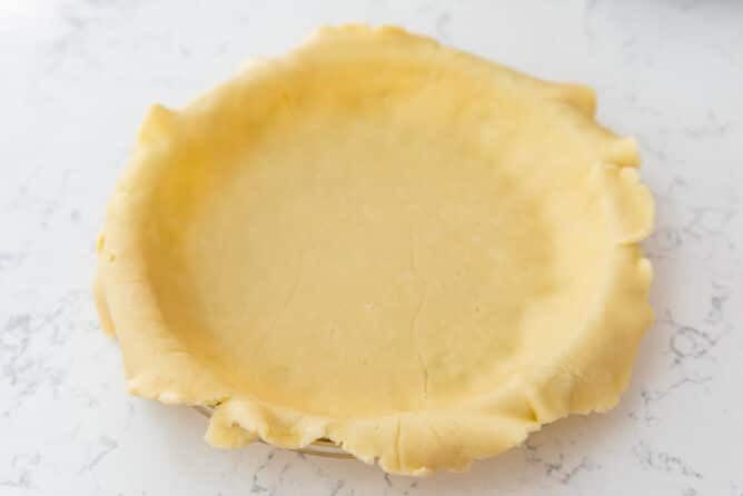 Pie crust laid inside the pie dish before baking