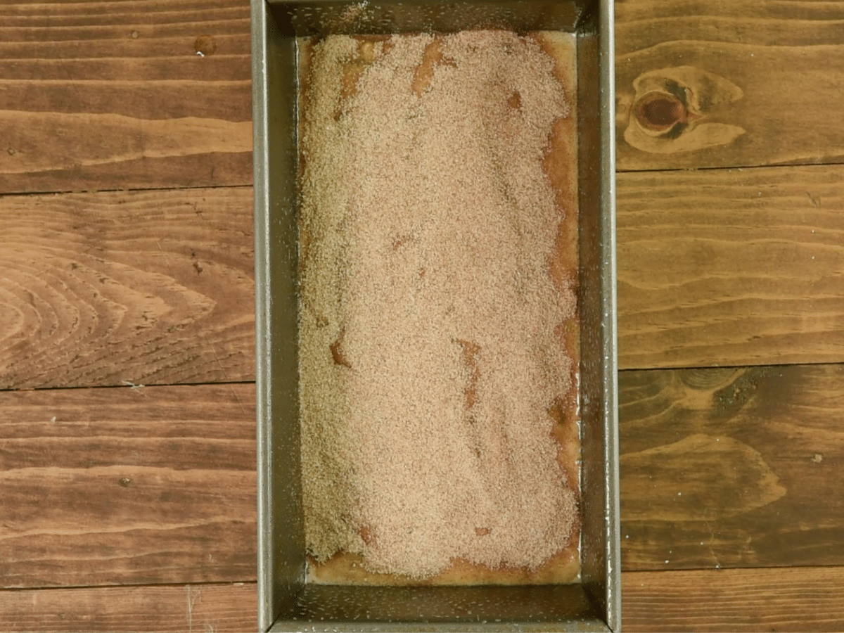 bread batter in pan with cinnamon sugar on top.
