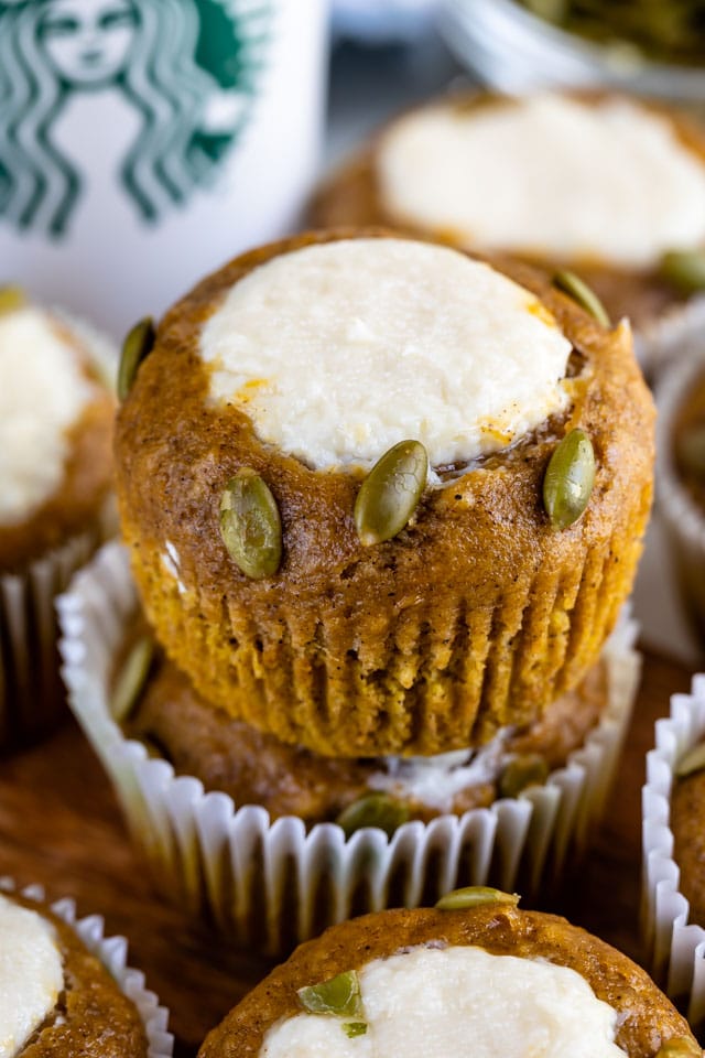 Close up of pumpkin cream cheese muffins stacked on top of eachother
