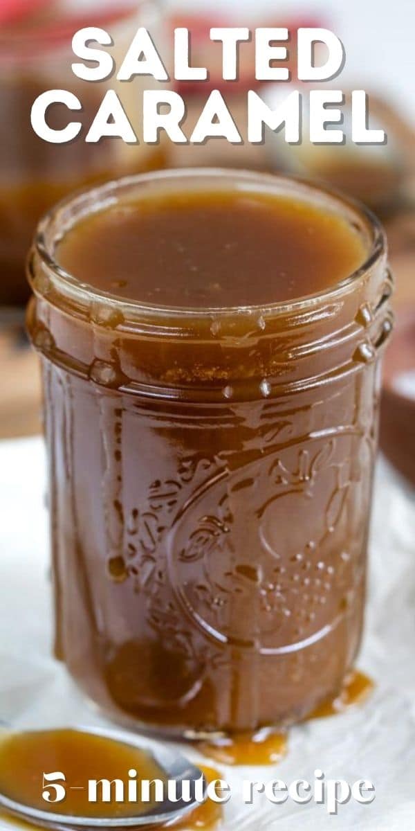 Mason jar full of salted caramel with a spoon full next to it with recipe title on top