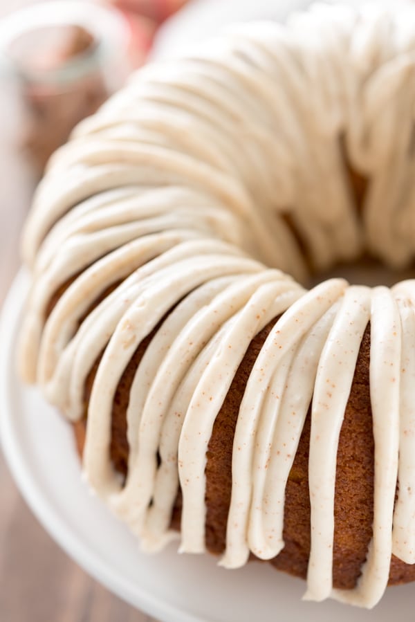 Overhead shot of half of the pumpkin bundt cake with ribbon like frosting