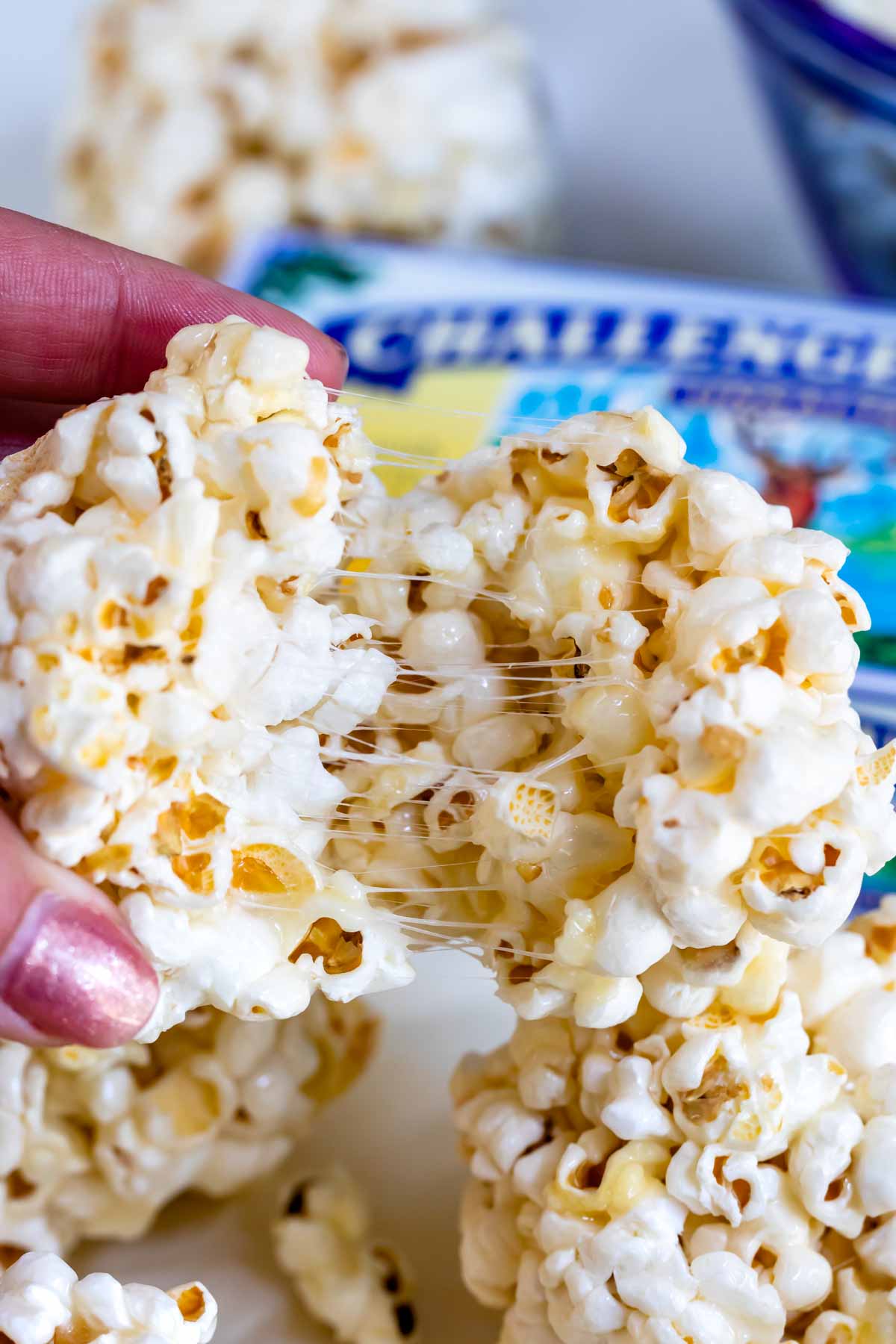 hand pulling apart gooey popcorn ball