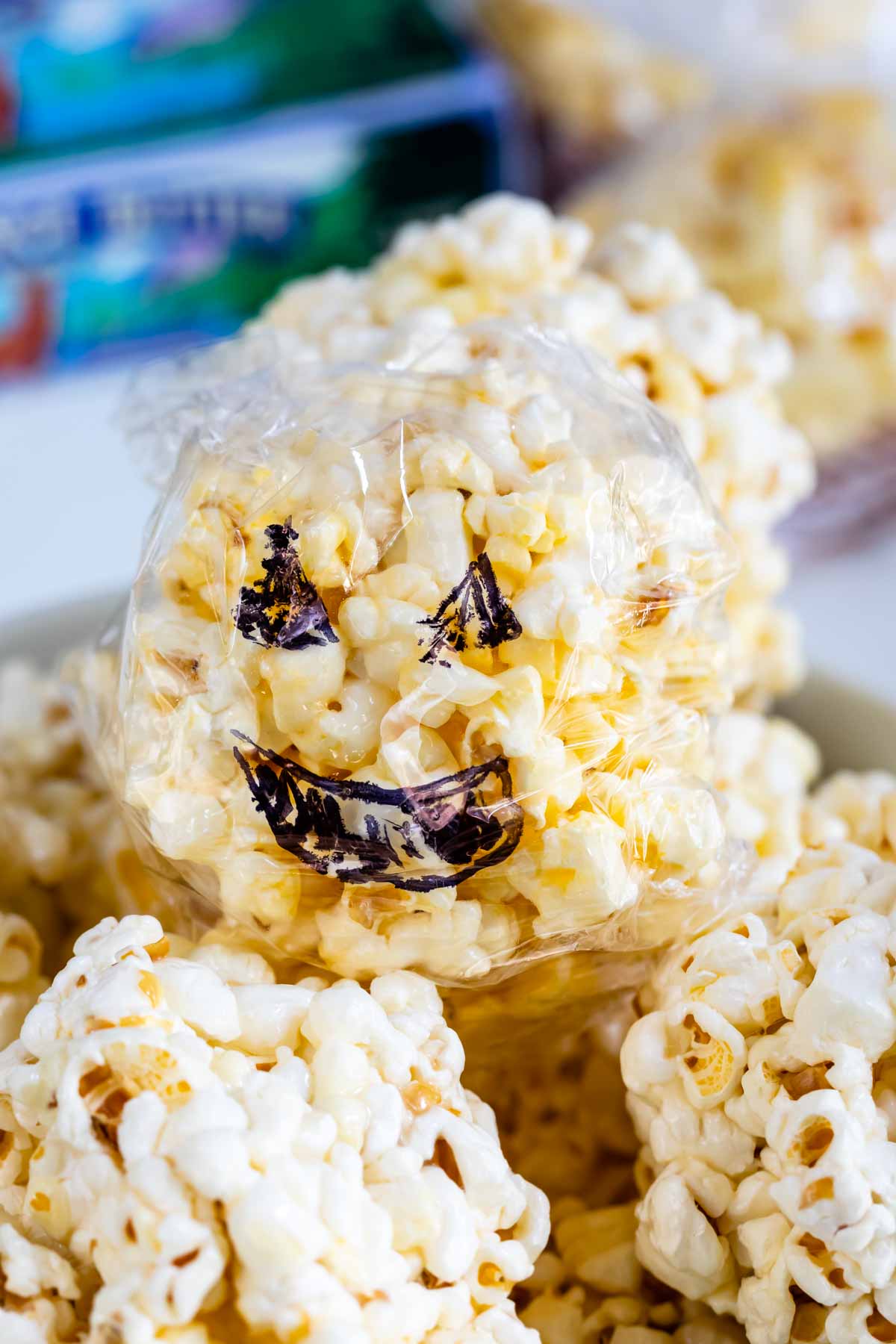 popcorn ball covered in plastic with jack o' lantern design