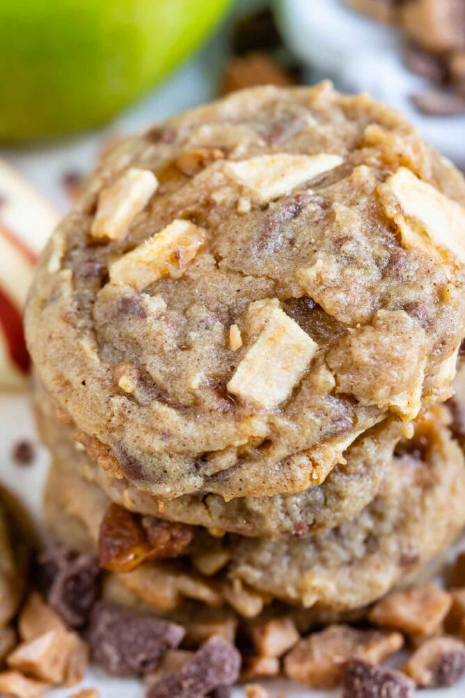 Close up photo of stack of apple cookies with toffee bits all around