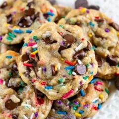 Overhead shot of birthday cookies with rainbow sprinkles on a white plate