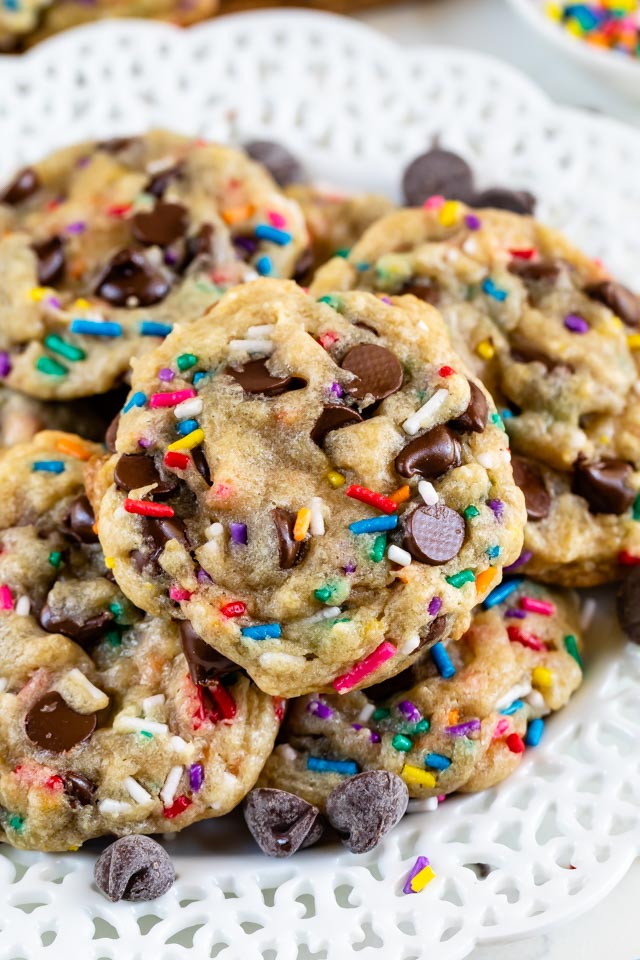 Overhead shot of birthday cookies with rainbow sprinkles on a white plate