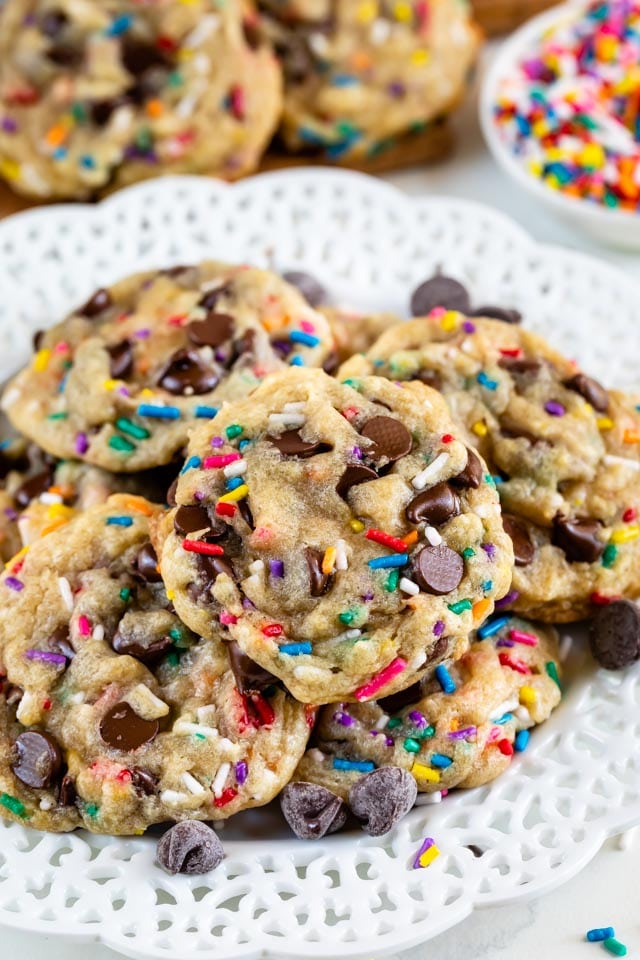 Overhead shot of birthday cookies with rainbow sprinkles on a white plate