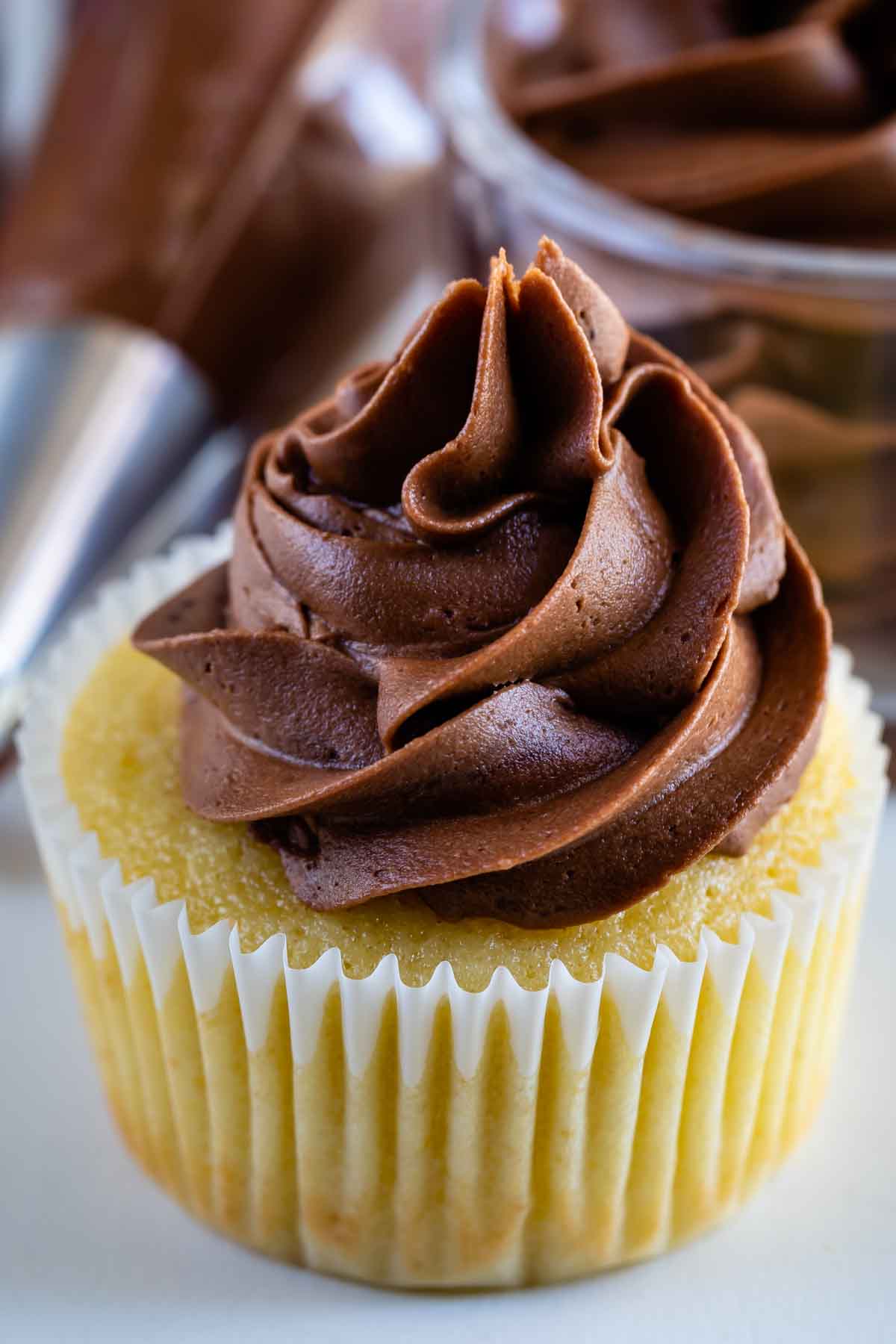yellow cupcake with chocolate frosting