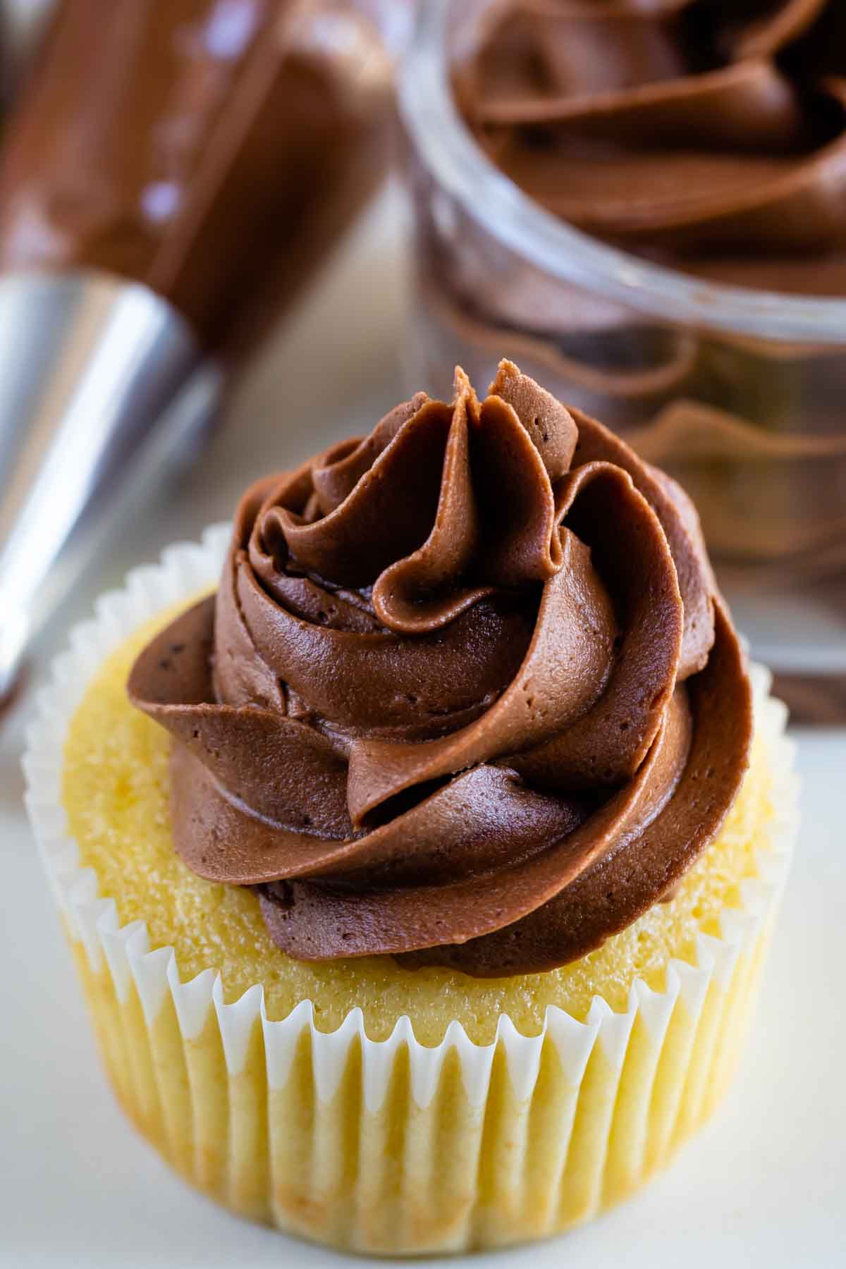 yellow cupcake with chocolate frosting