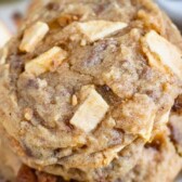 Close up photo of stack of apple cookies with toffee bits all around and recipe title on top of photo