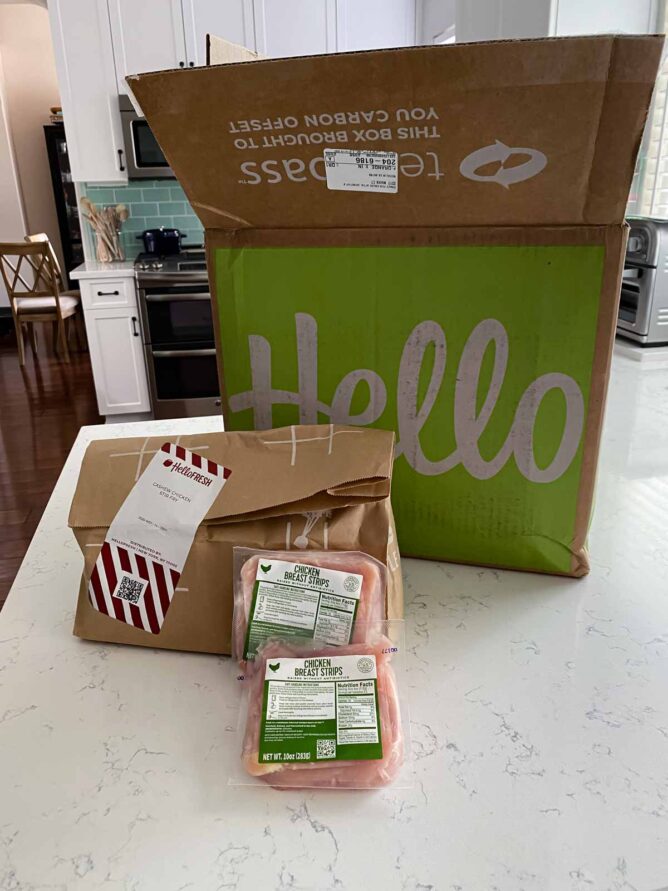 hello fresh box with meal kit on counter and bags of chicken