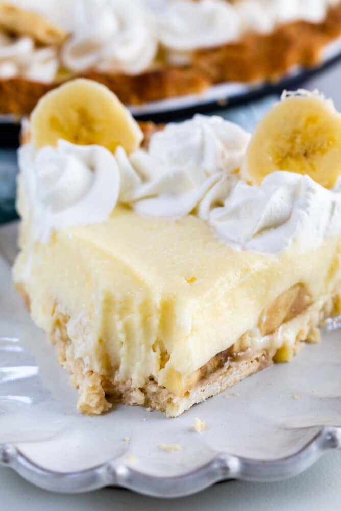 Slice of banana cream pie with one bite missing