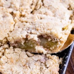 sliced apple slab pie in sheet pan with spatula