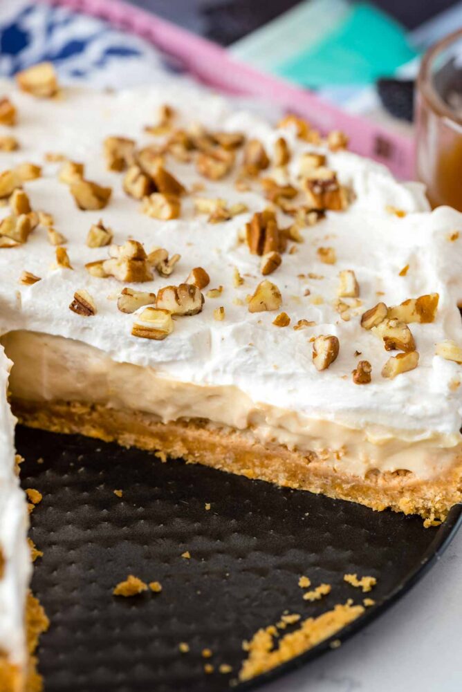 Close up shot of butterscotch pie with one slice missing