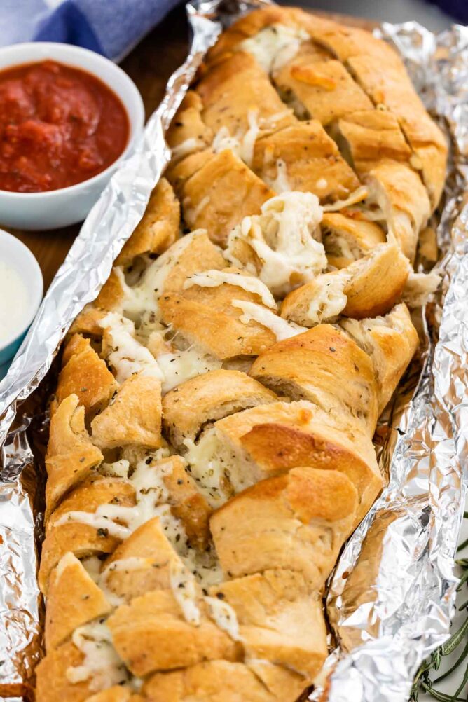 French bread stuffed with cheese in foil