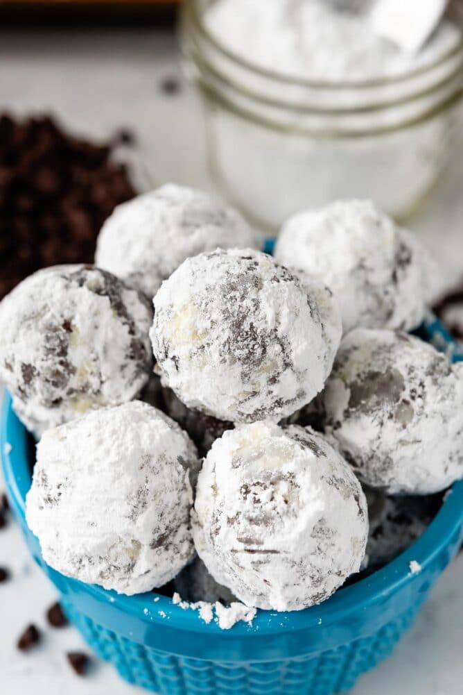 snowball cookies stacked in blue bowl