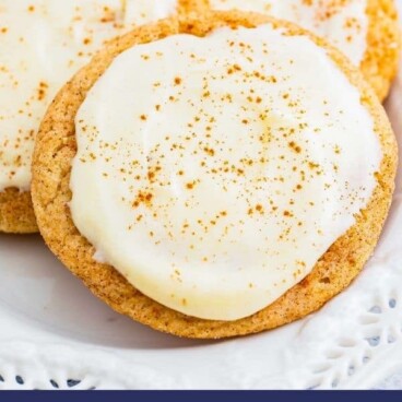 Eggnog snickerdoodles with eggnog frosting on a plate with recipe title on bottom of photo