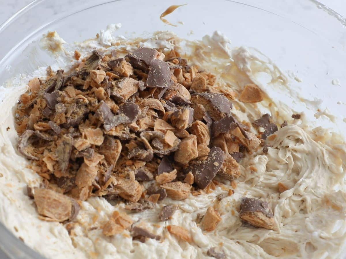 peanut butter mixture in large bowl with butterfinger pieces.