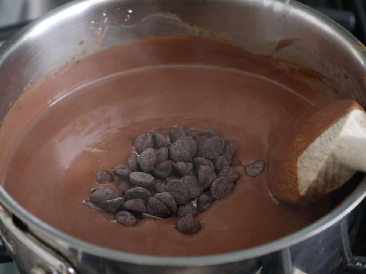 saucepan with thickened chocolate pudding and chocolate chips.